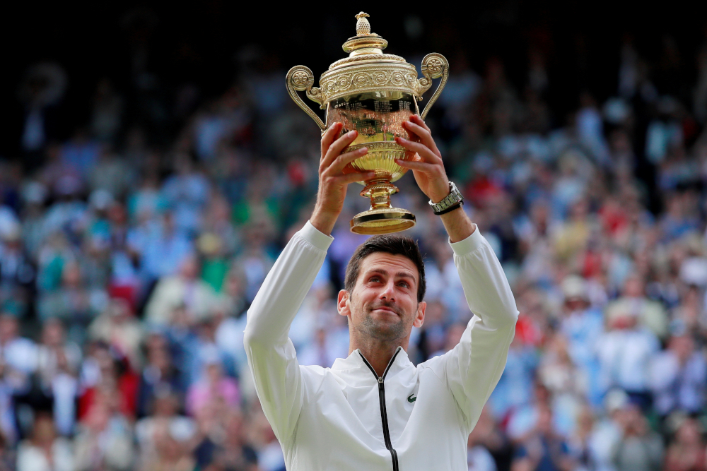 Serbia's Novak Djokovic poses with the Wimbledon trophy in London July 14, 2019, after defeating Switzerland's Roger Federer in five sets. (CNS/Reuters/Andrew Couldridge)