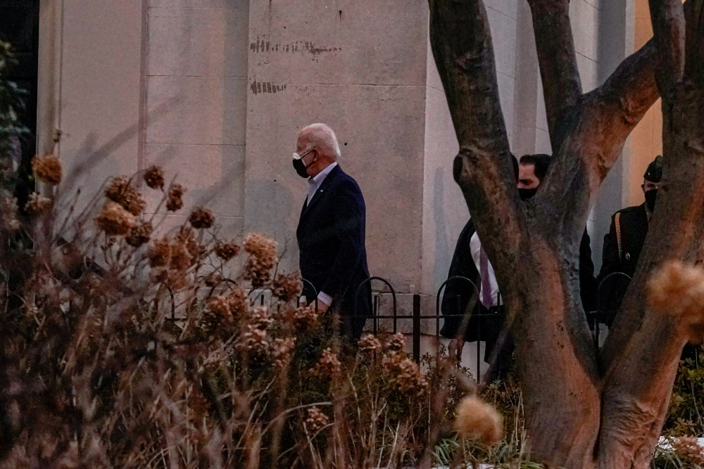 President Joe Biden walks into Holy Trinity Catholic Church to attend Mass Feb. 20 in Washington. (CNS/Reuters/Ken Cedeno)