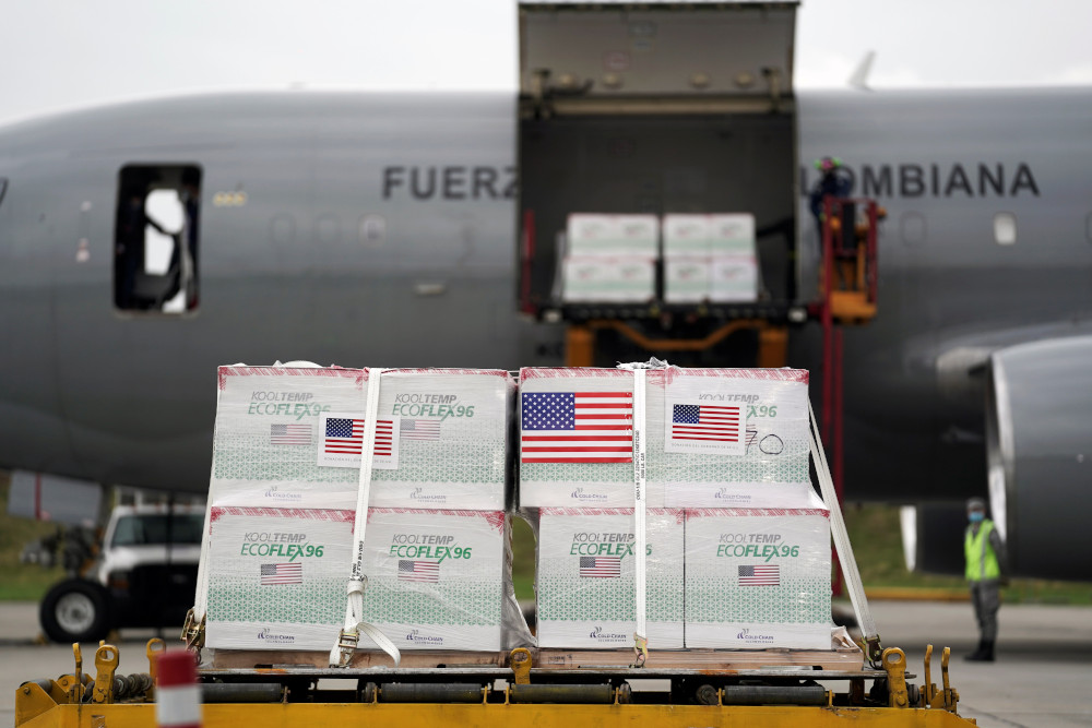 U.S. flags are taped on a shipment of Johnson & Johnson COVID-19 vaccines in Bogota, Colombia, July 1. (CNS photo/Nathalia Angarita, Reuters)