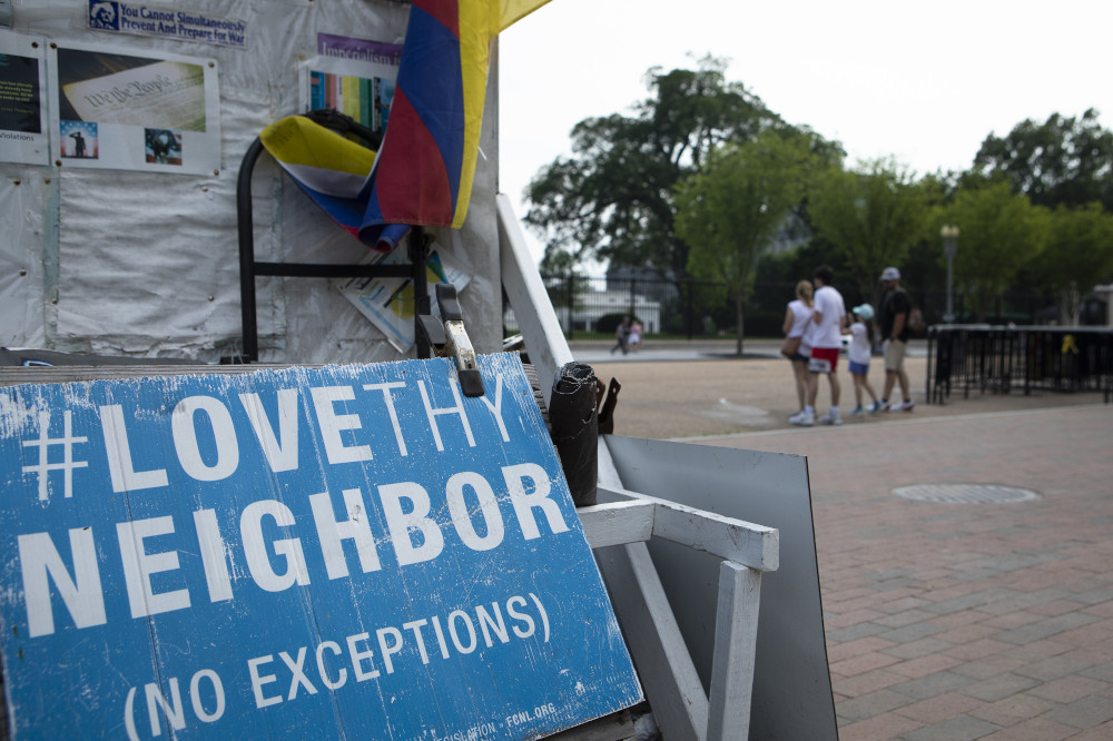 A "Love Thy Neighbor: No Exceptions" sign is seen near the White House in Washington July 7. (CNS/Tyler Orsburn)