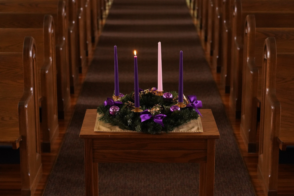 A lit candle is seen on a wreath for the first Sunday of Advent in this illustration photo. (CNS/Gregory A. Shemitz)