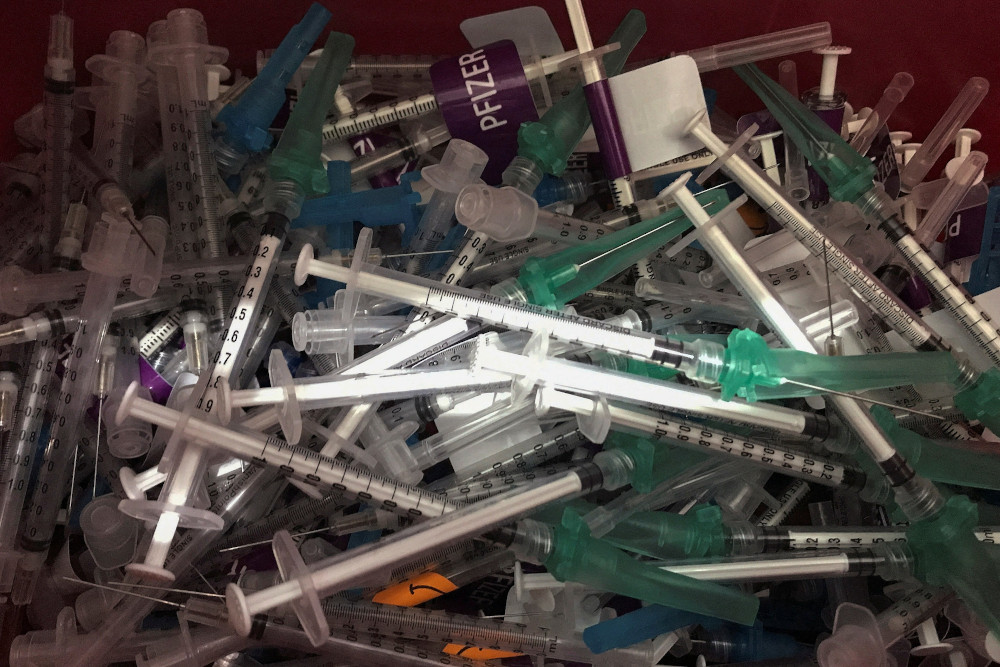 A bin of discarded syringes used to administer COVID-19 vaccines is pictured in New York City Dec. 17, 2021. (CNS/Reuters/Carlo Allegri)