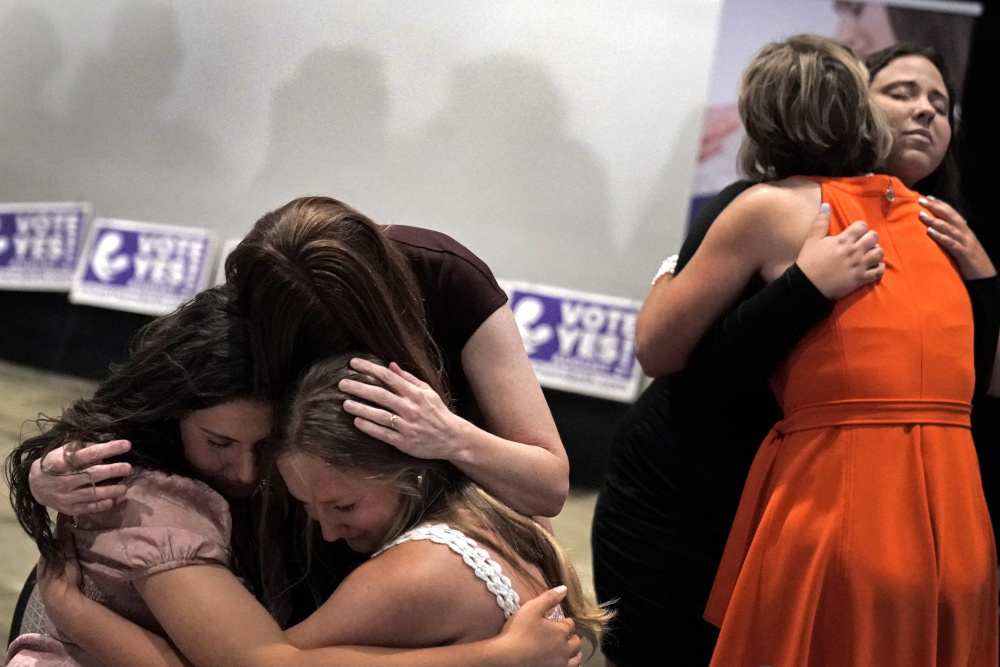 People hug during a "Value Them Both" watch party after a question involving a constitutional amendment removing abortion protections from the Kansas constitution failed Aug. 2 in Overland Park, Kansas. (AP/Charlie Riedel)