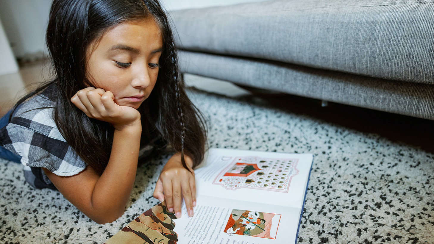 A child reads a sample of "The Book of Belonging." (Photo by Daniel Ebersole) A child reads a sample of "The Book of Belonging." (Photo by Daniel Ebersole)