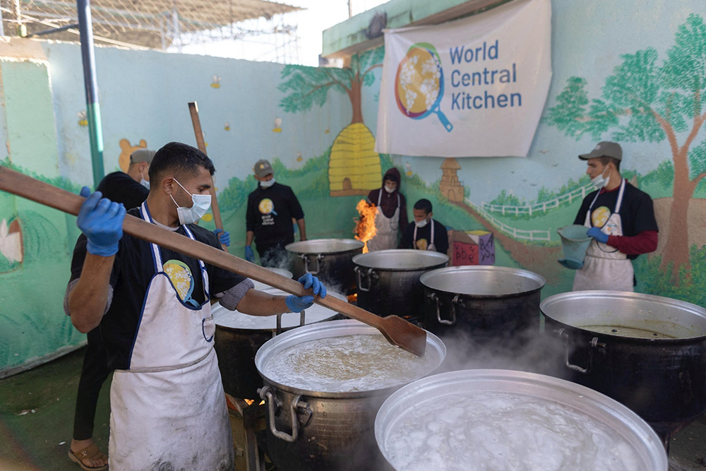 Members of the World Central Kitchen prepare food for Palestinians in a location given as Gaza amid the ongoing conflict between Israel and Hamas, in this picture released on March 21, 2024 and obtained from social media. (OSV News/Courtesy of @chefjoseandres via X via Reuters)